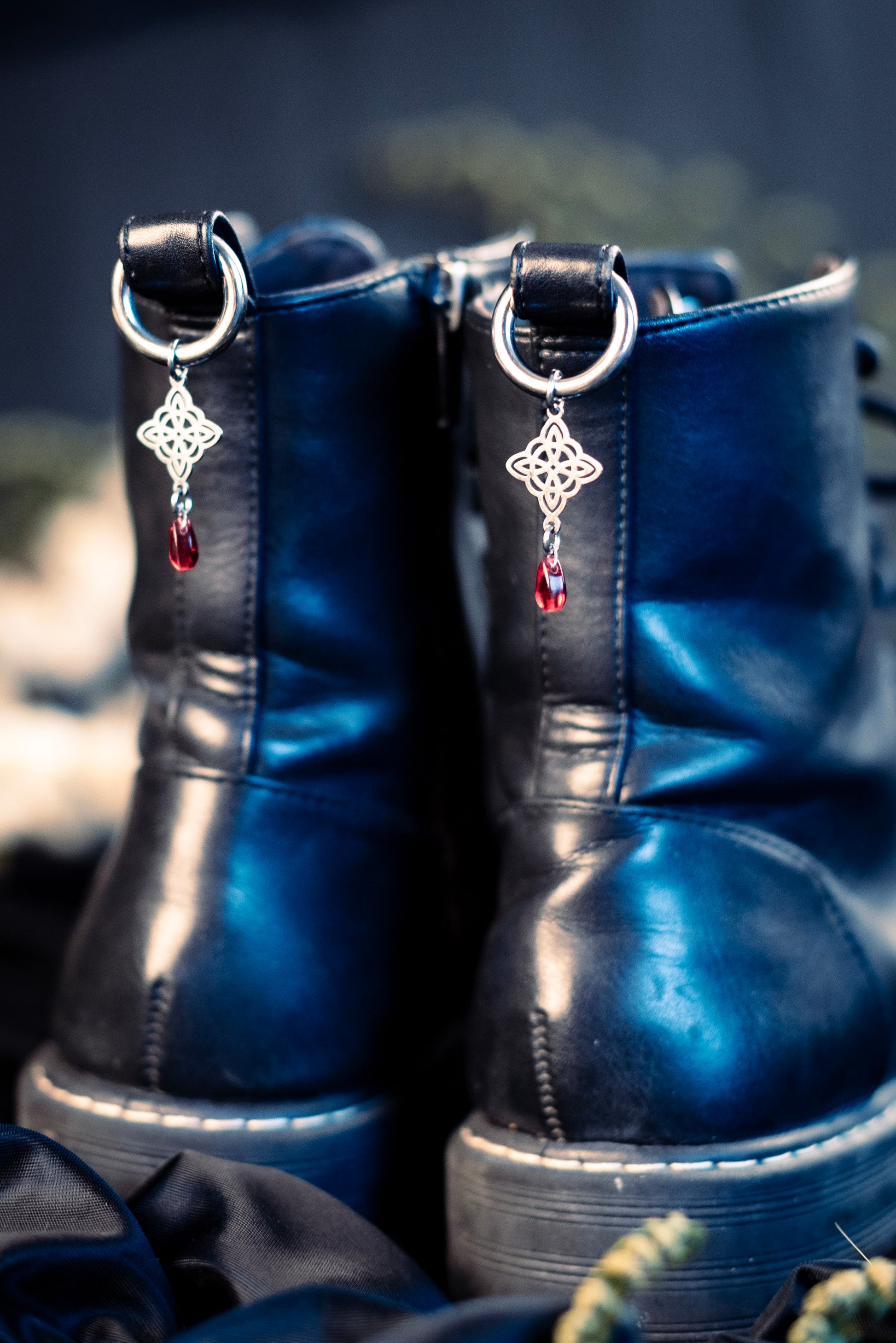 witch's knot shoe charms featuring a red glass bead and a stainless steel  hoop clasp 