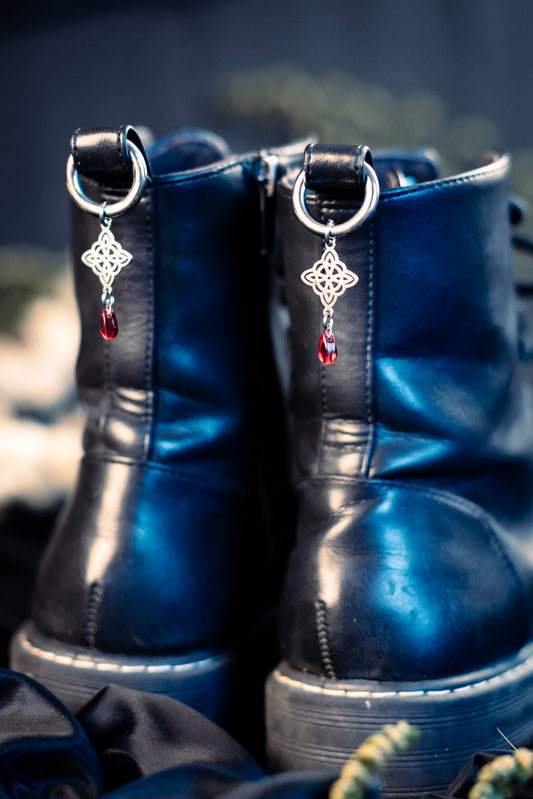 witch's knot shoe charms featuring a red glass bead and a stainless steel  hoop clasp 