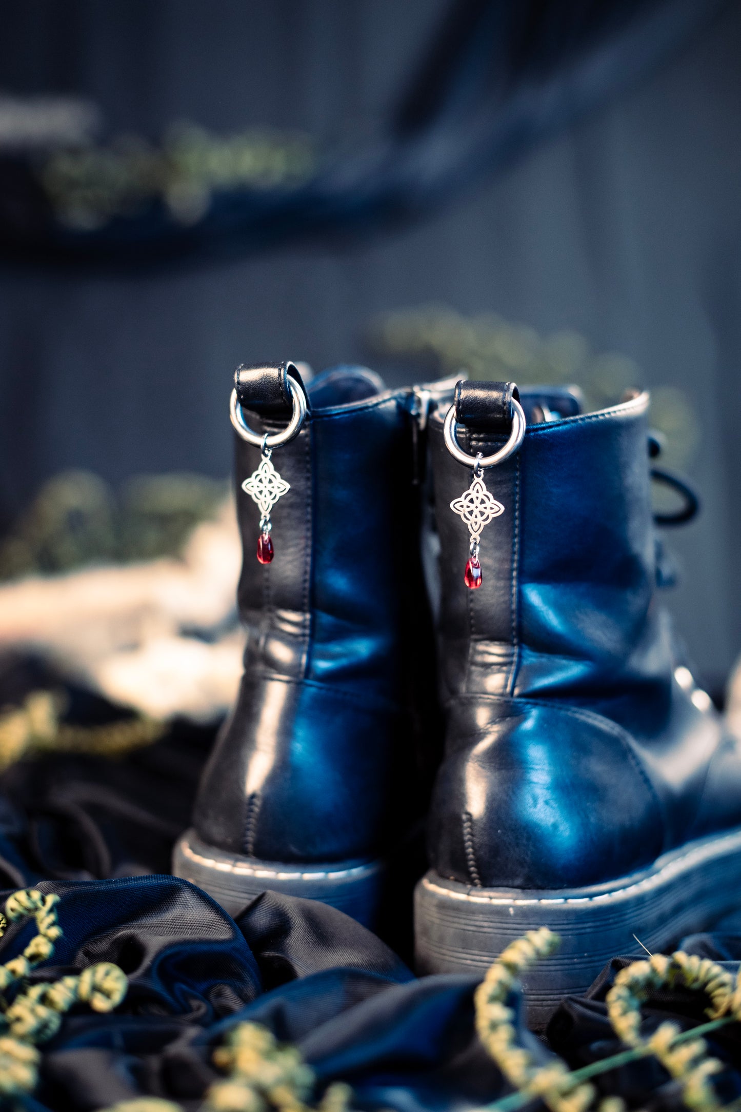 witch's knot shoe charms featuring a red glass bead and a stainless steel  hoop clasp 