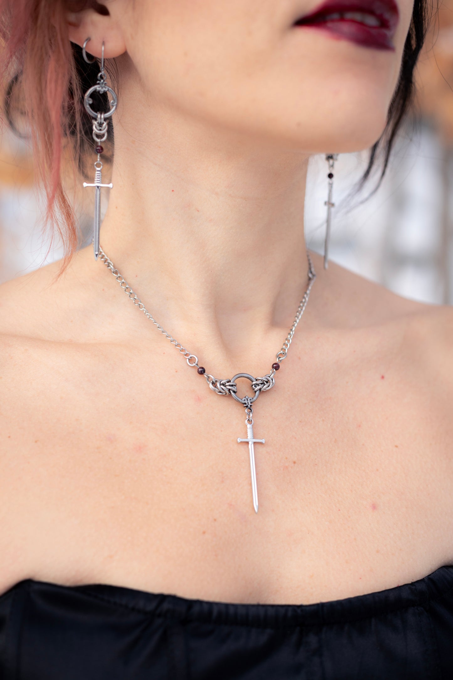 ARIA | Chainmail Earrings
Stainless steel chainmail earrings with a garnet stone and a silver sword