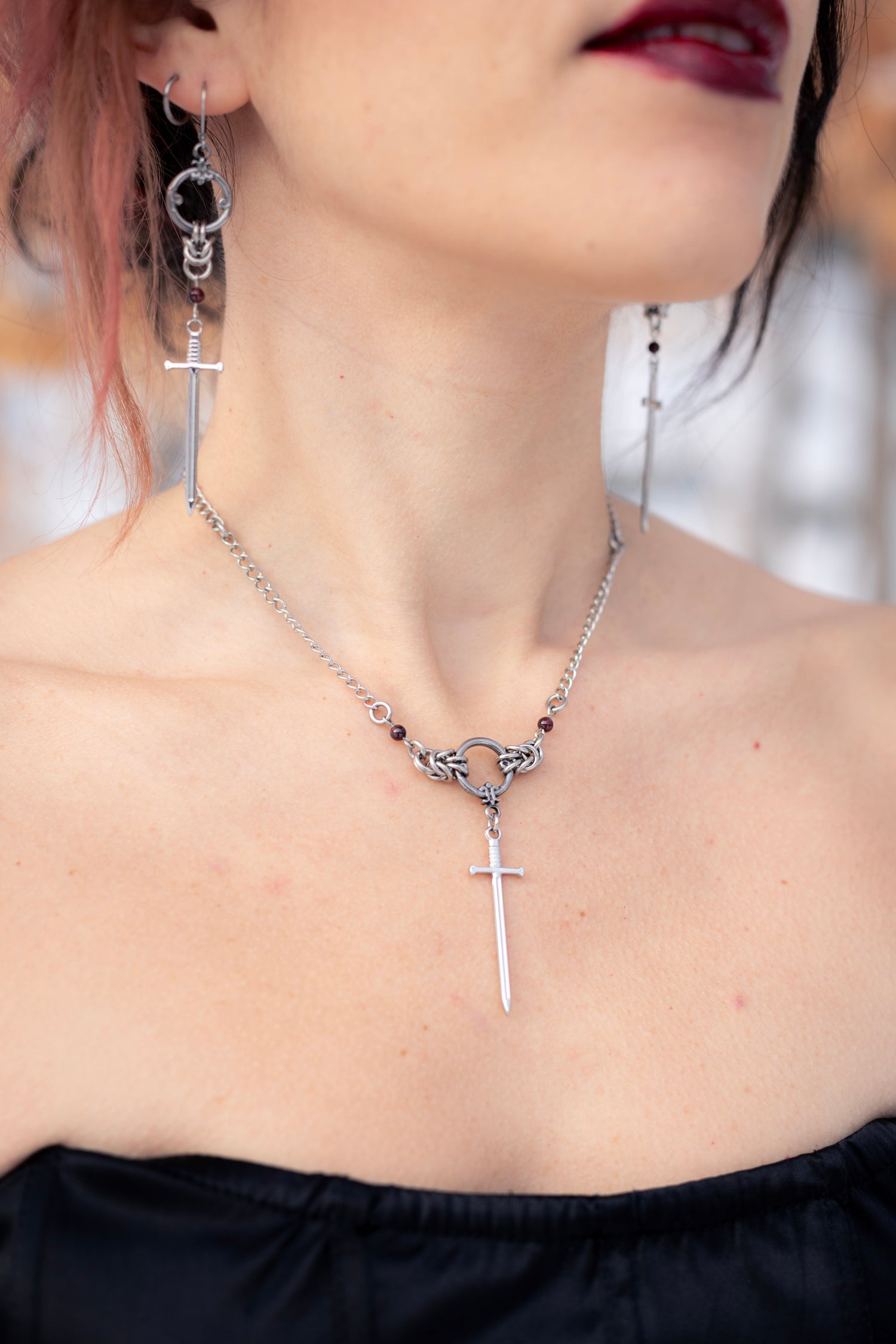 ARIA | Chainmail Earrings
Stainless steel chainmail earrings with a garnet stone and a silver sword