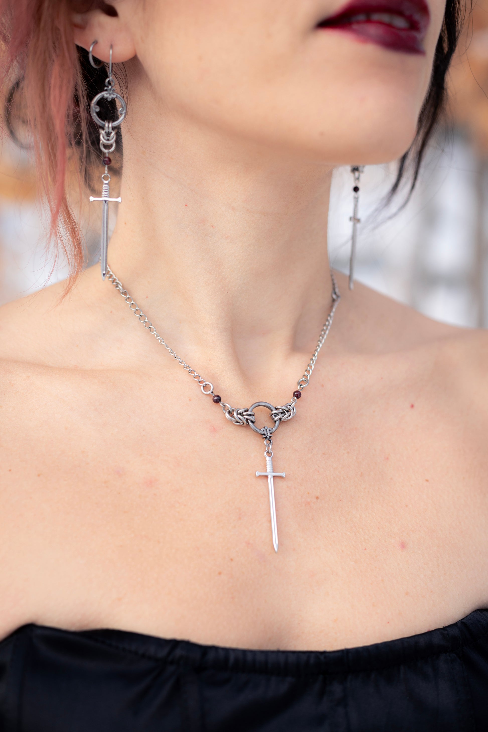 ARIA | Chainmail Earrings
Stainless steel chainmail earrings with a garnet stone and a silver sword